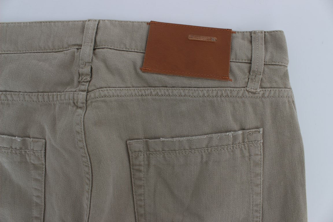 Pair of khaki cargo pants with a brown leather patch on the right side