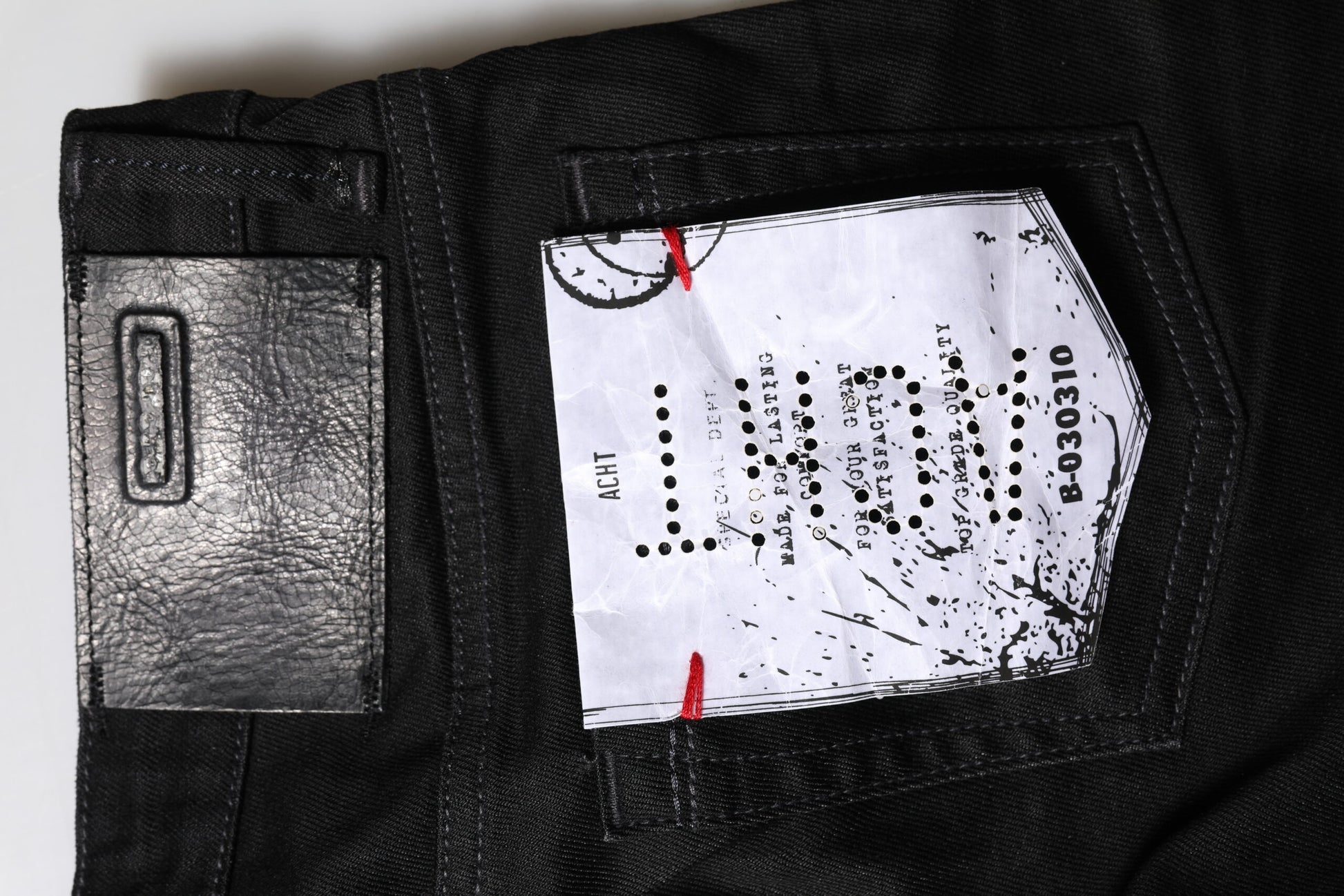Pair of jeans with a card in the back pocket