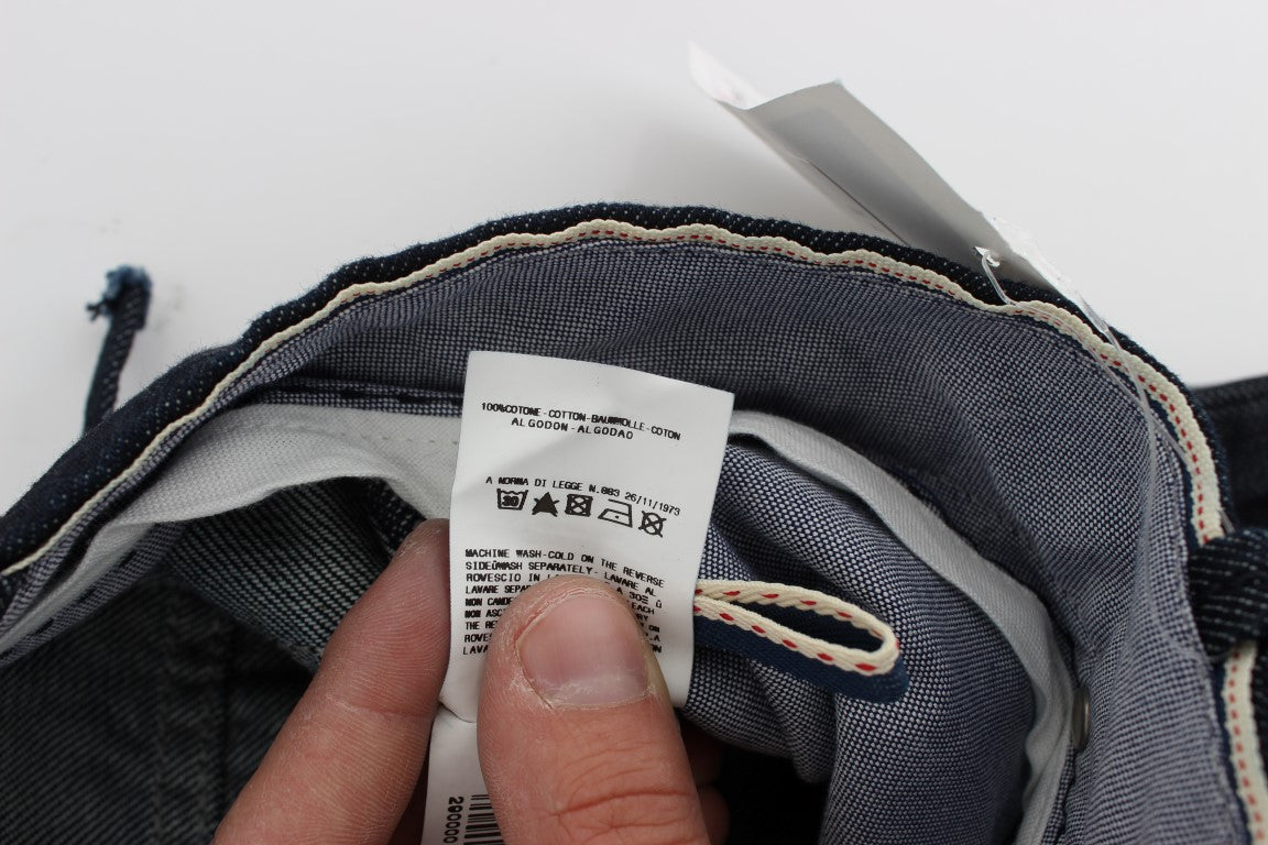 Hand holding a tag on denim jeans