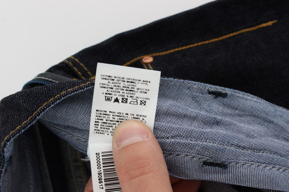 Hand holding blue jeans with white label on waistband