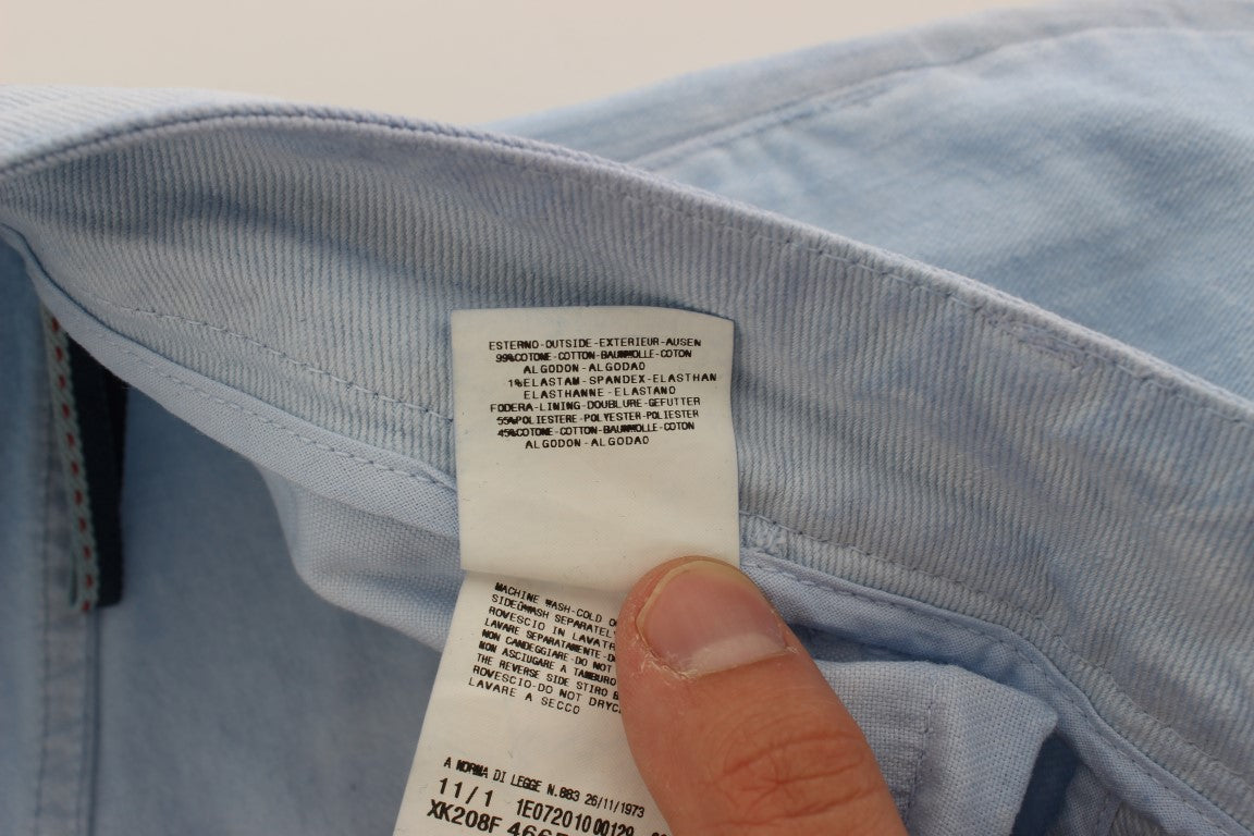 Hand holding tag on blue denim shirt