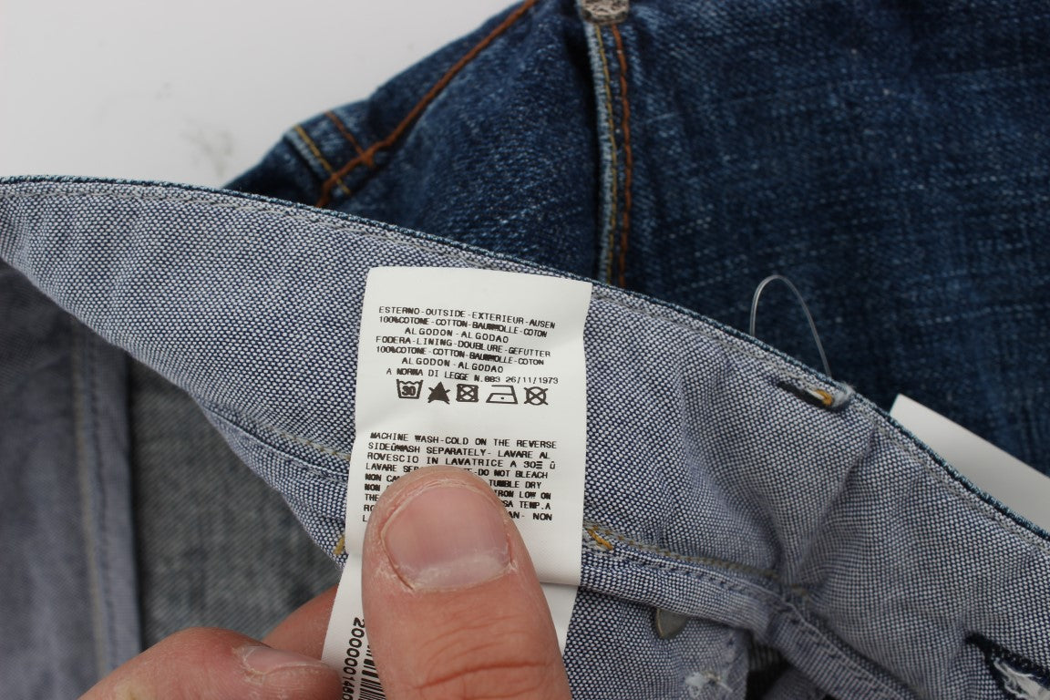 Hand holding a white tag on blue denim jeans