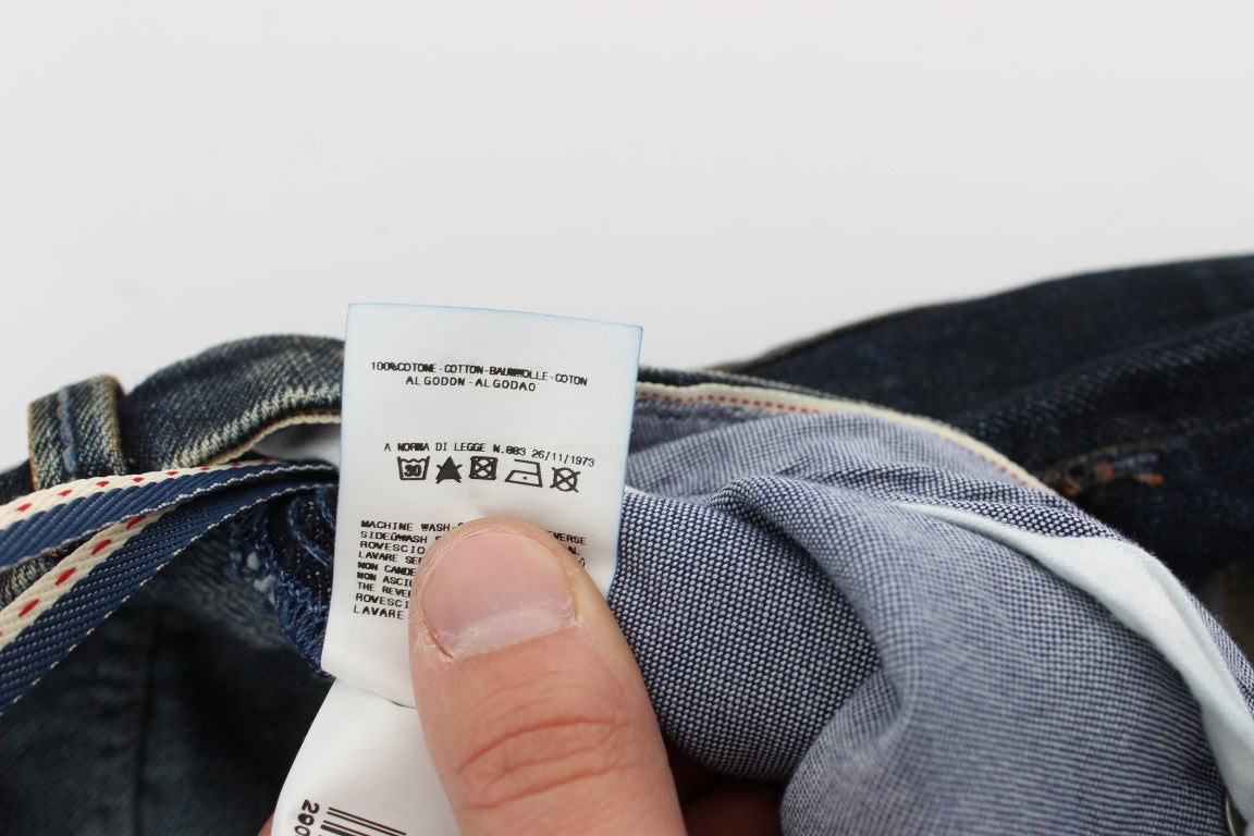 Hand holding a tag on blue jeans