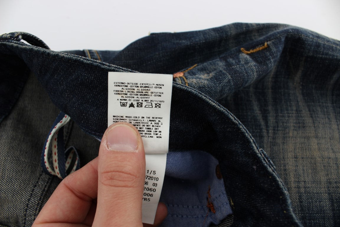 Hand holding a white tag on blue denim jeans
