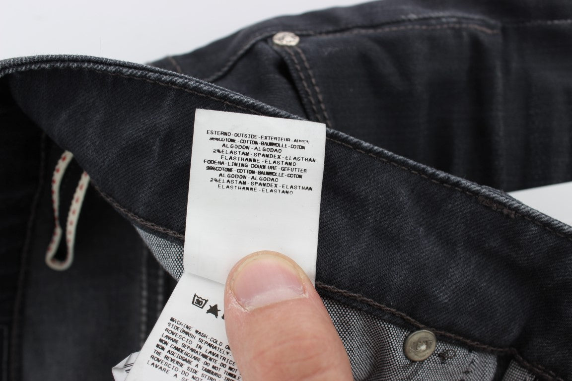 Hand holding a tag on a pair of jeans