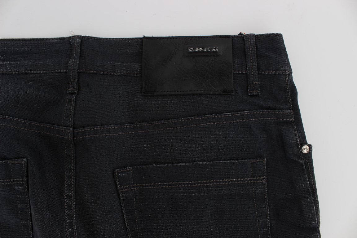 Pair of black denim jeans with a label on the waistband