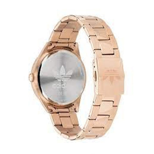 A copper rose gold watch with a white face featuring an adidas logo