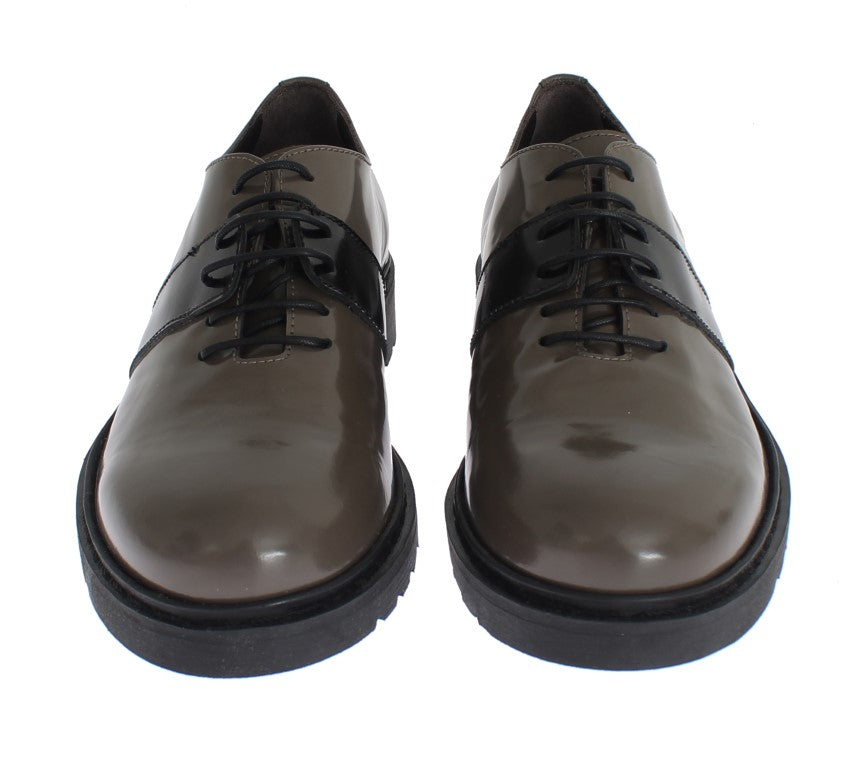 Pair of brown leather shoes with black laces and soles