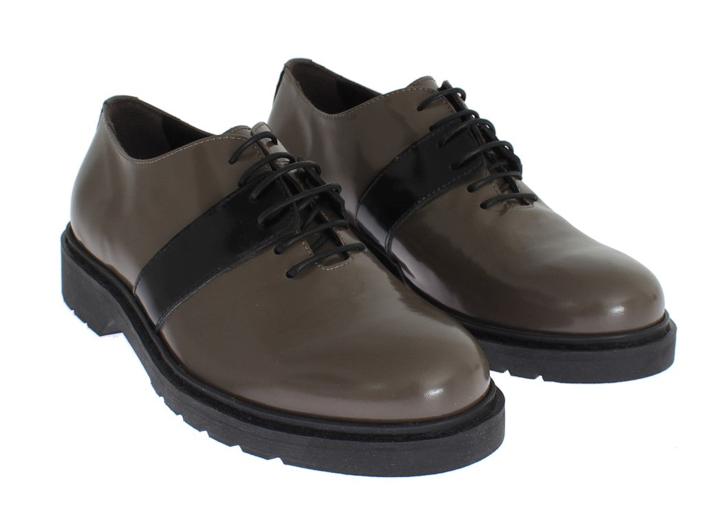 Pair of brown leather shoes with laces and black trim