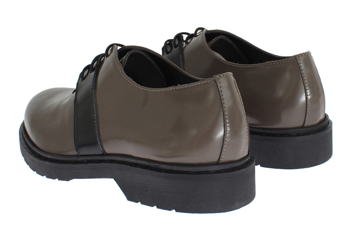 Pair of brown leather shoes with laces and a strap across the top