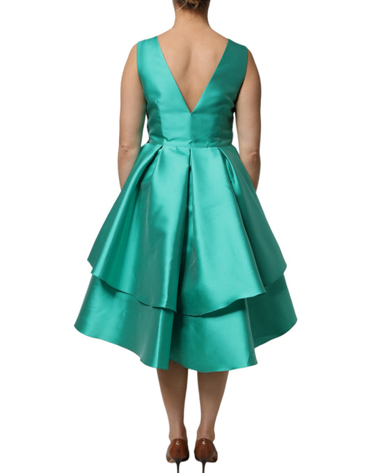 A green satin polyester sleeveless dress with a V-neck and layered design