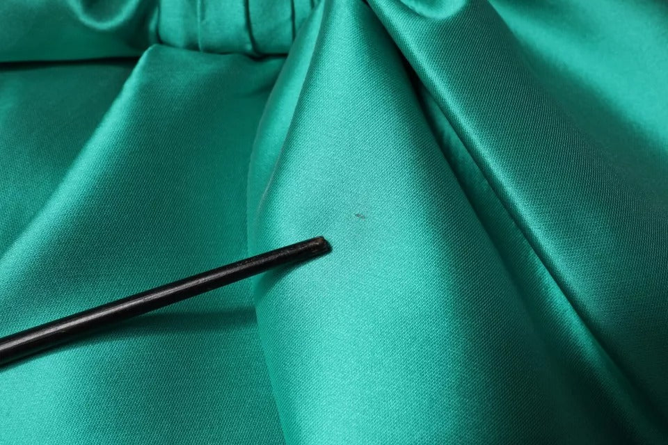 A green satin polyester sleeveless dress with a V-neck and layered design