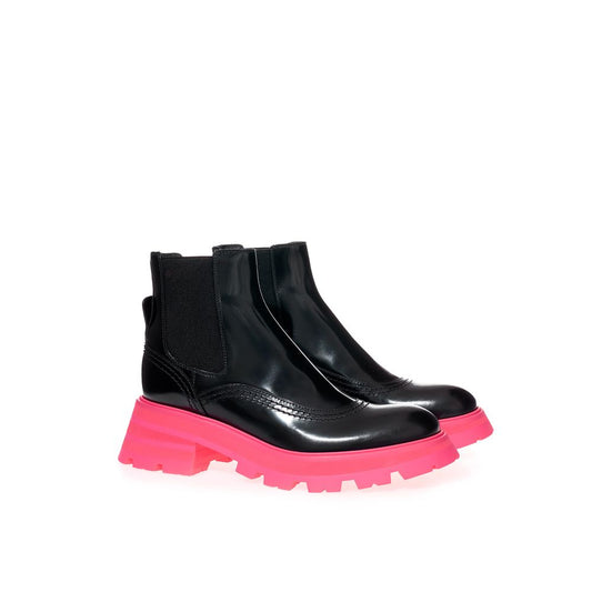 Black rubber boot with pink sole and laces