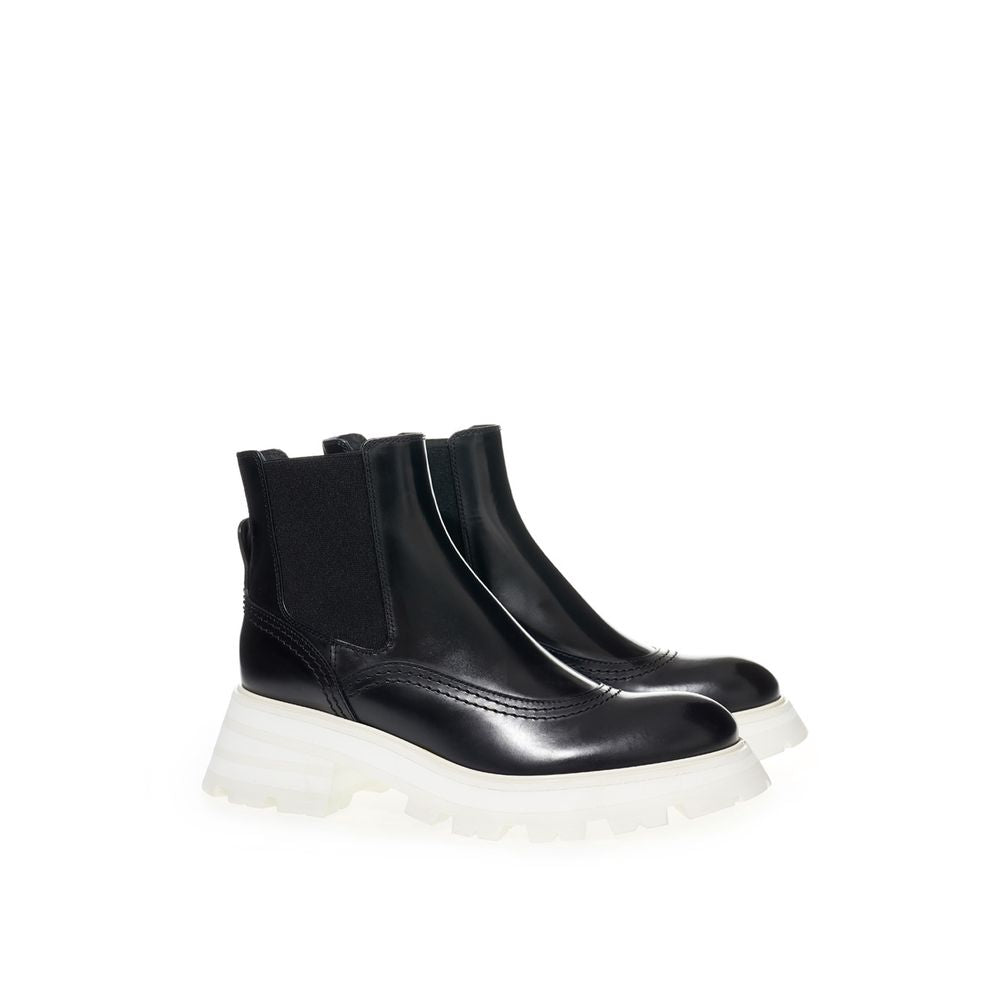 Black ankle boot with white sole and laces