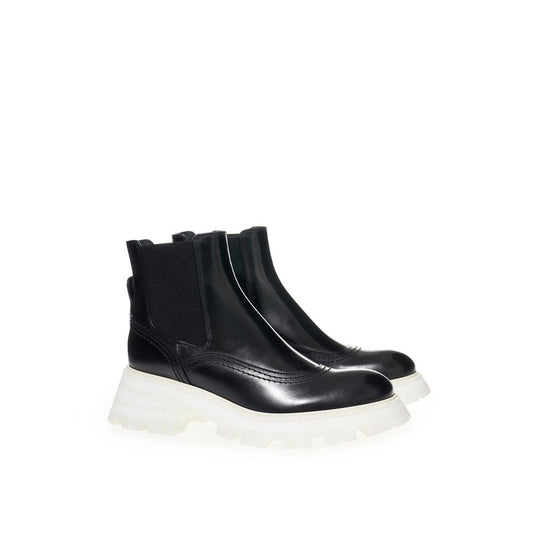 Black ankle boot with white sole and laces