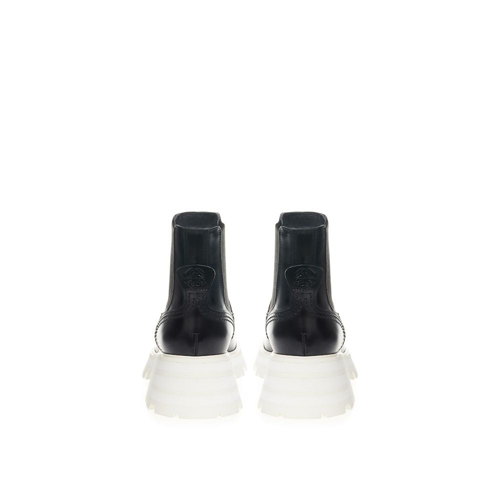 Pair of black boots with white soles