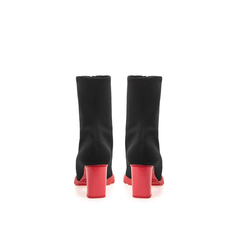 Pair of black knee high boots with red heels