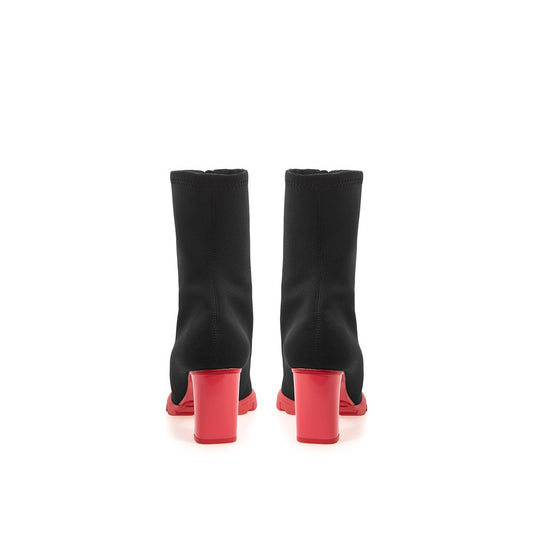 Pair of black knee high boots with red heels