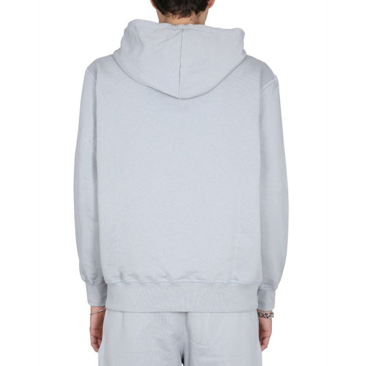The back view of a person wearing a light gray hoodie