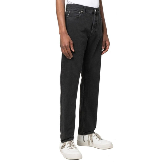 Man wearing black pants and white sneakers