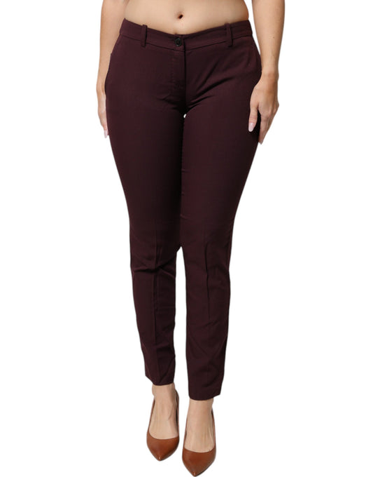A pair of maroon mid-waist tapered skinny dress pants