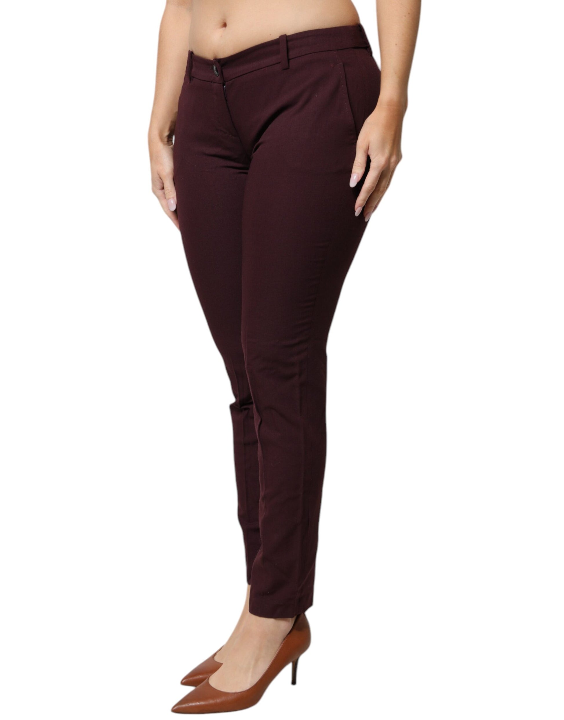 A pair of maroon mid waist tapered skinny dress pants
