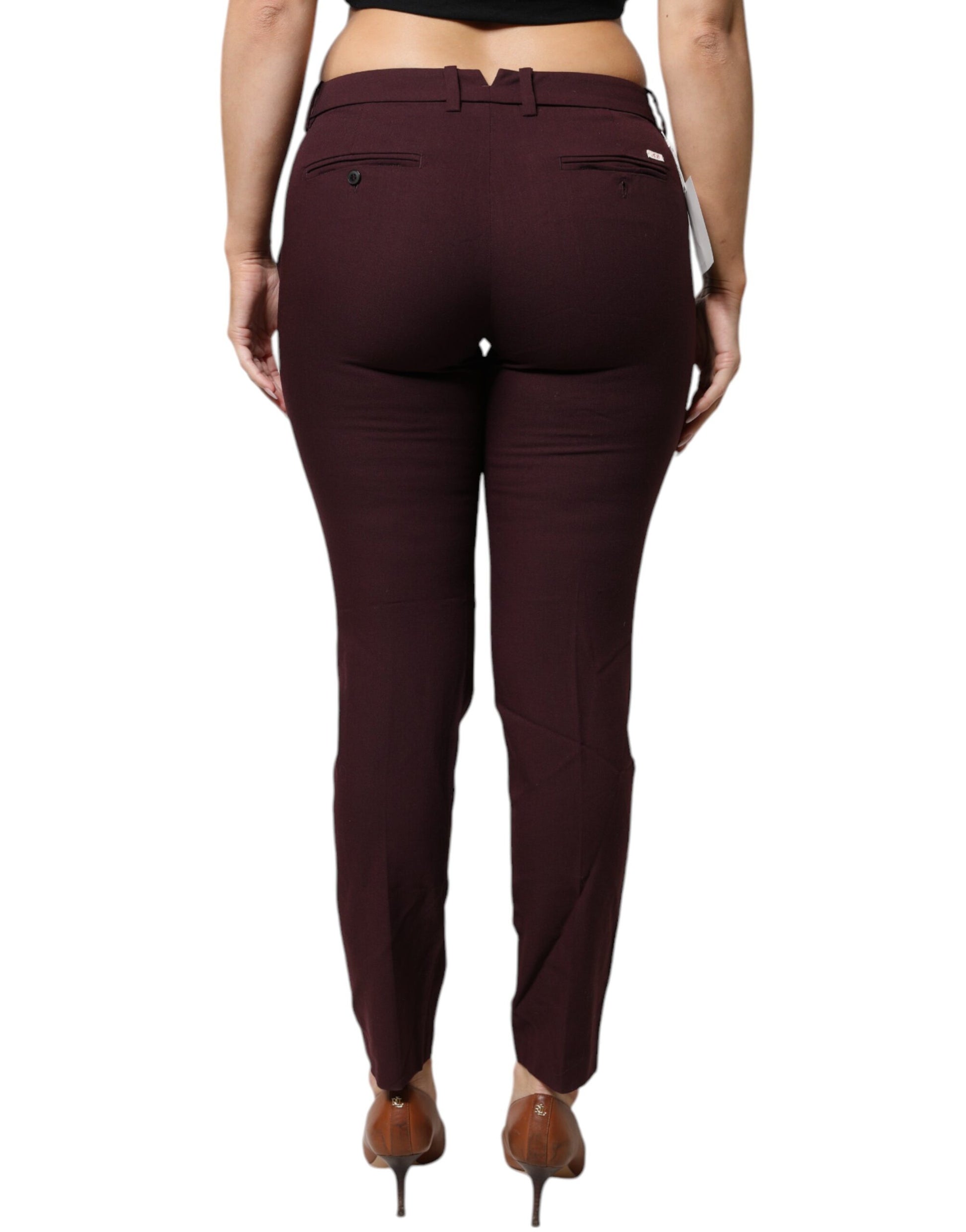 A pair of maroon mid waist tapered skinny dress pants