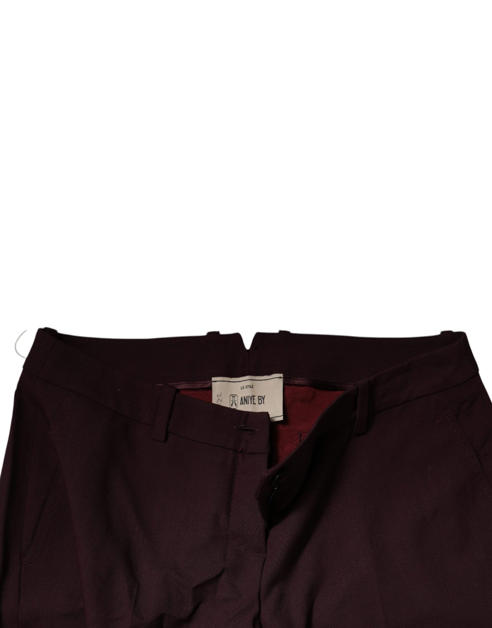 A pair of maroon mid waist tapered skinny dress pants with a tag visible on the inside