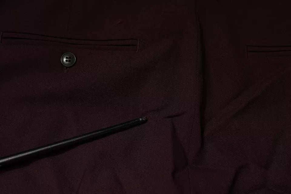 A pair of maroon mid-waist tapered skinny dress pants