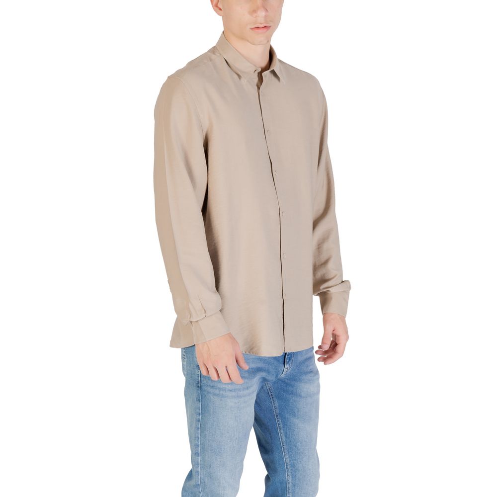 A beige dress shirt with long sleeves, worn by a mannequin