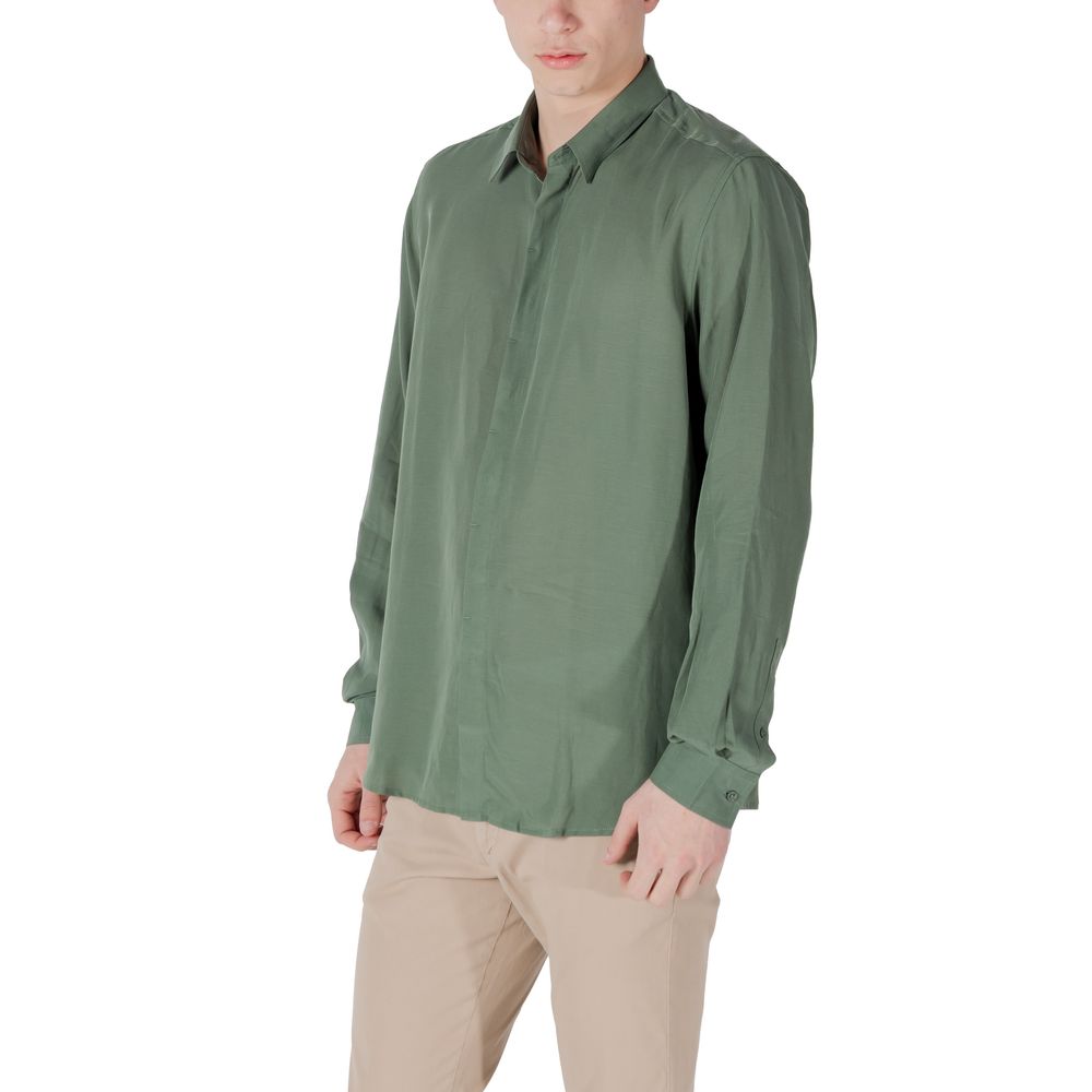 A green long sleeve dress shirt with a collar, worn by a mannequin