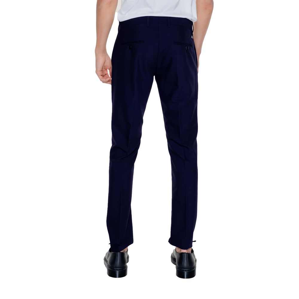 A pair of blue dress pants with a white shirt tucked in, worn by a mannequin
