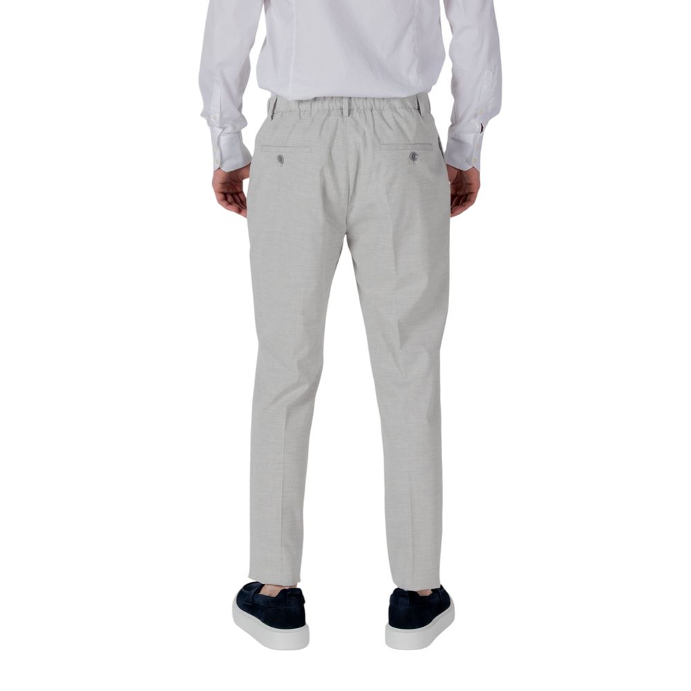A pair of gray polyester dress pants with a white shirt tucked in, worn by a mannequin