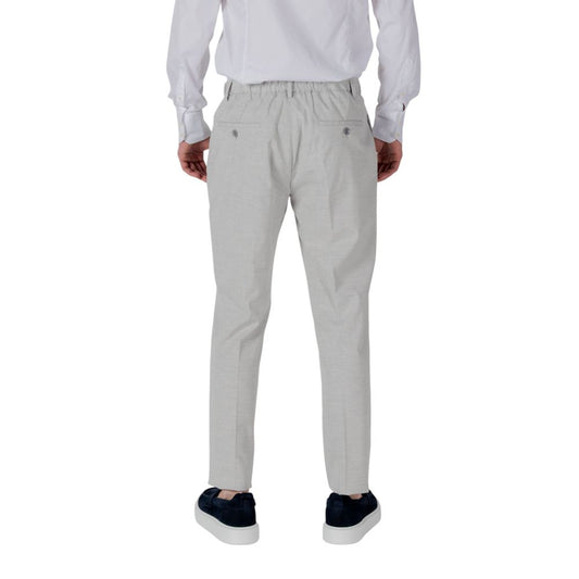 A pair of gray polyester dress pants with a white shirt tucked in, worn by a mannequin