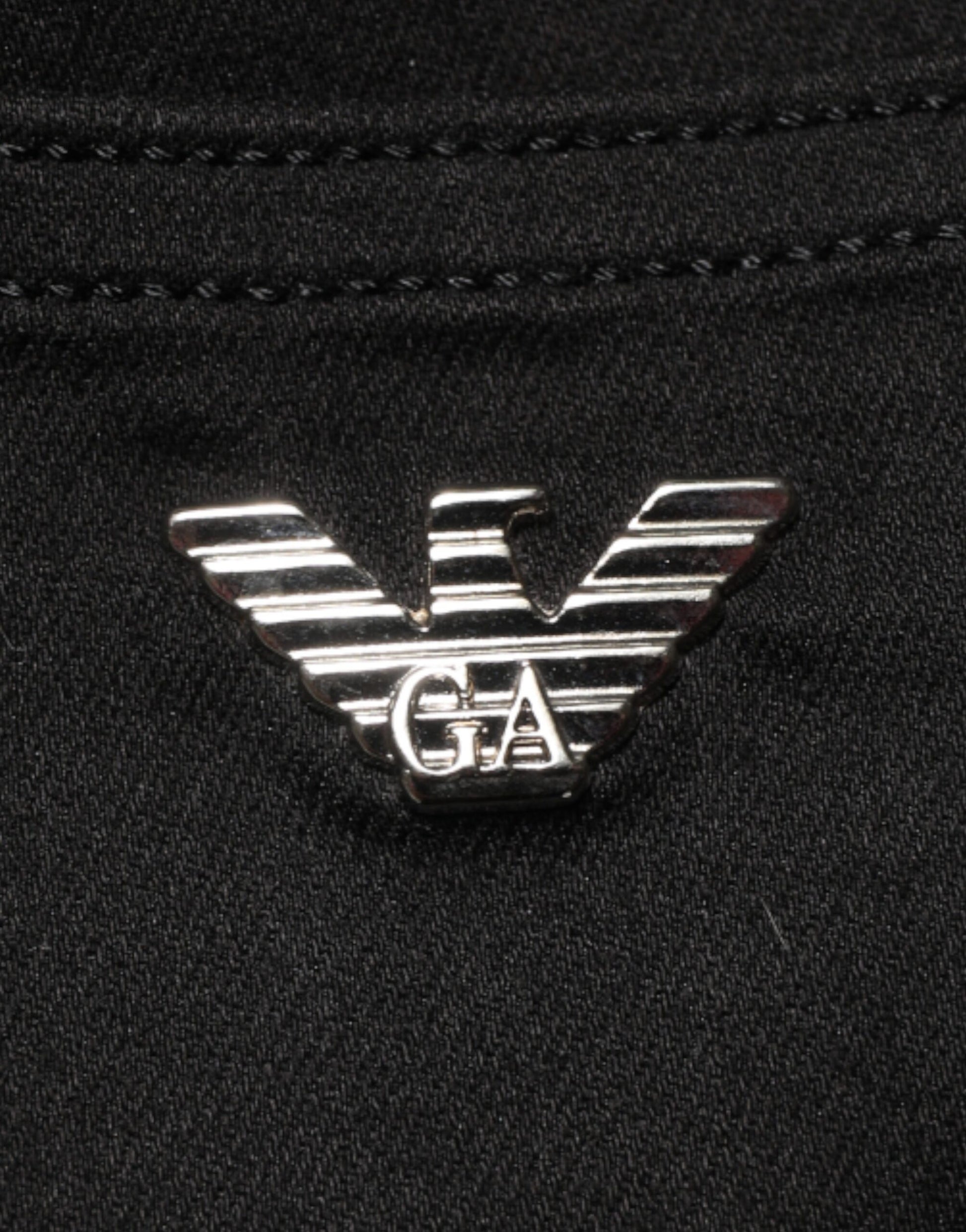 Silver logo on black fabric