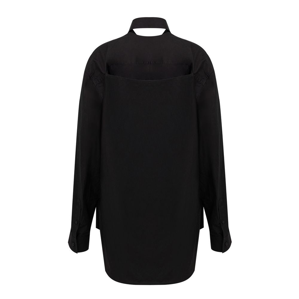 A long black cotton dress with a high neckline and long sleeves