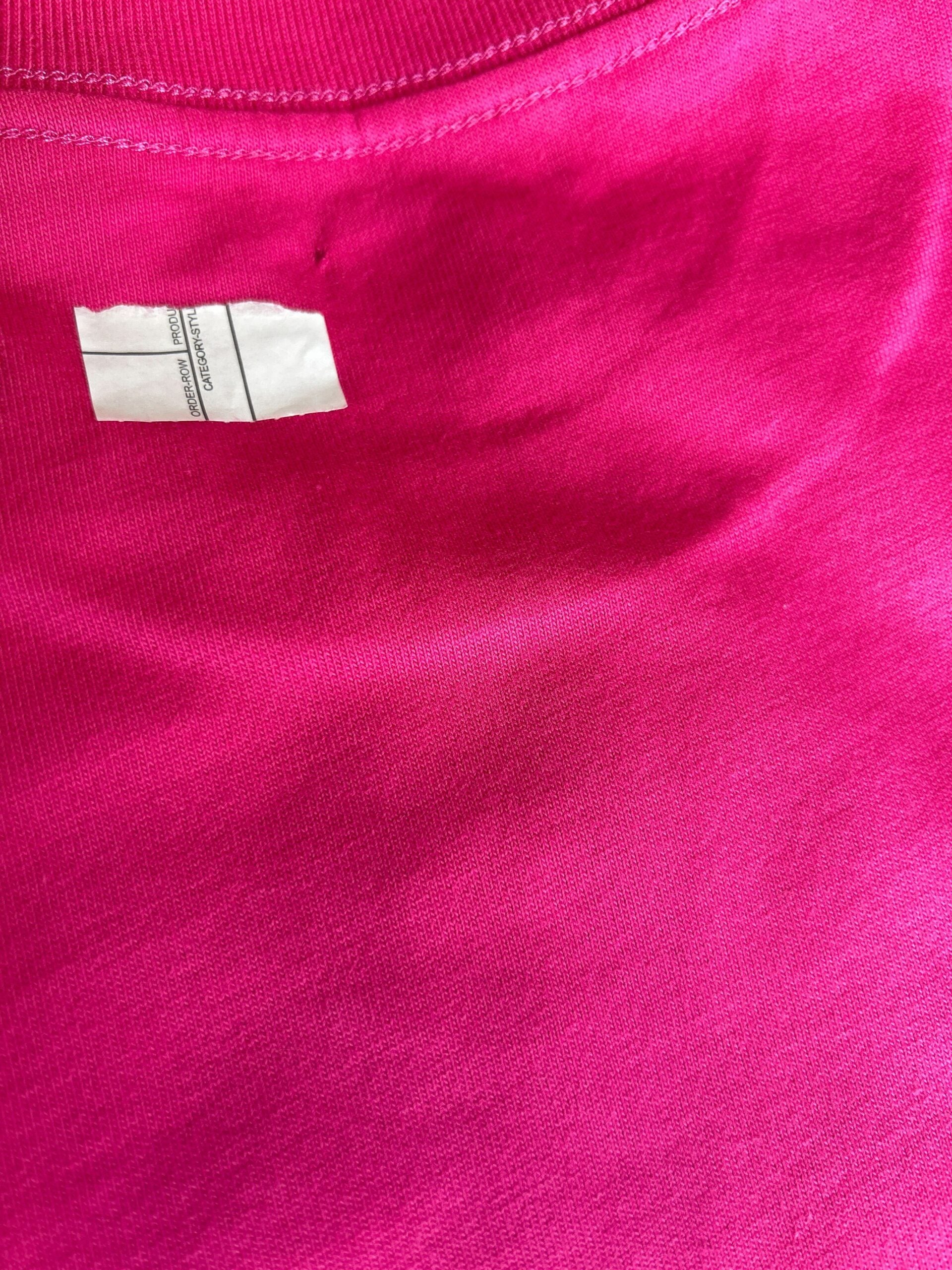 Pink fabric with tag inside neckline