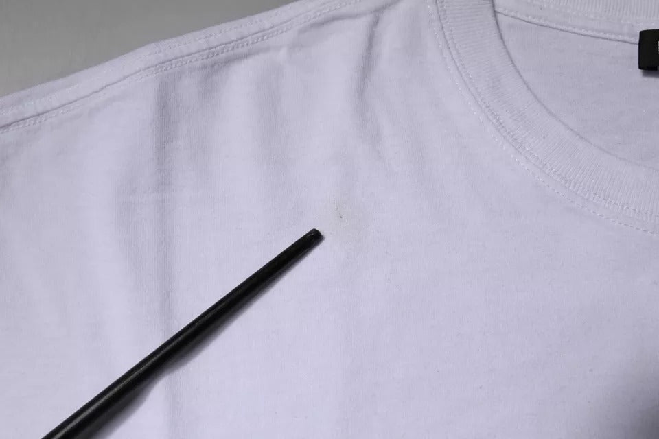White t-shirt with black chopsticks on it