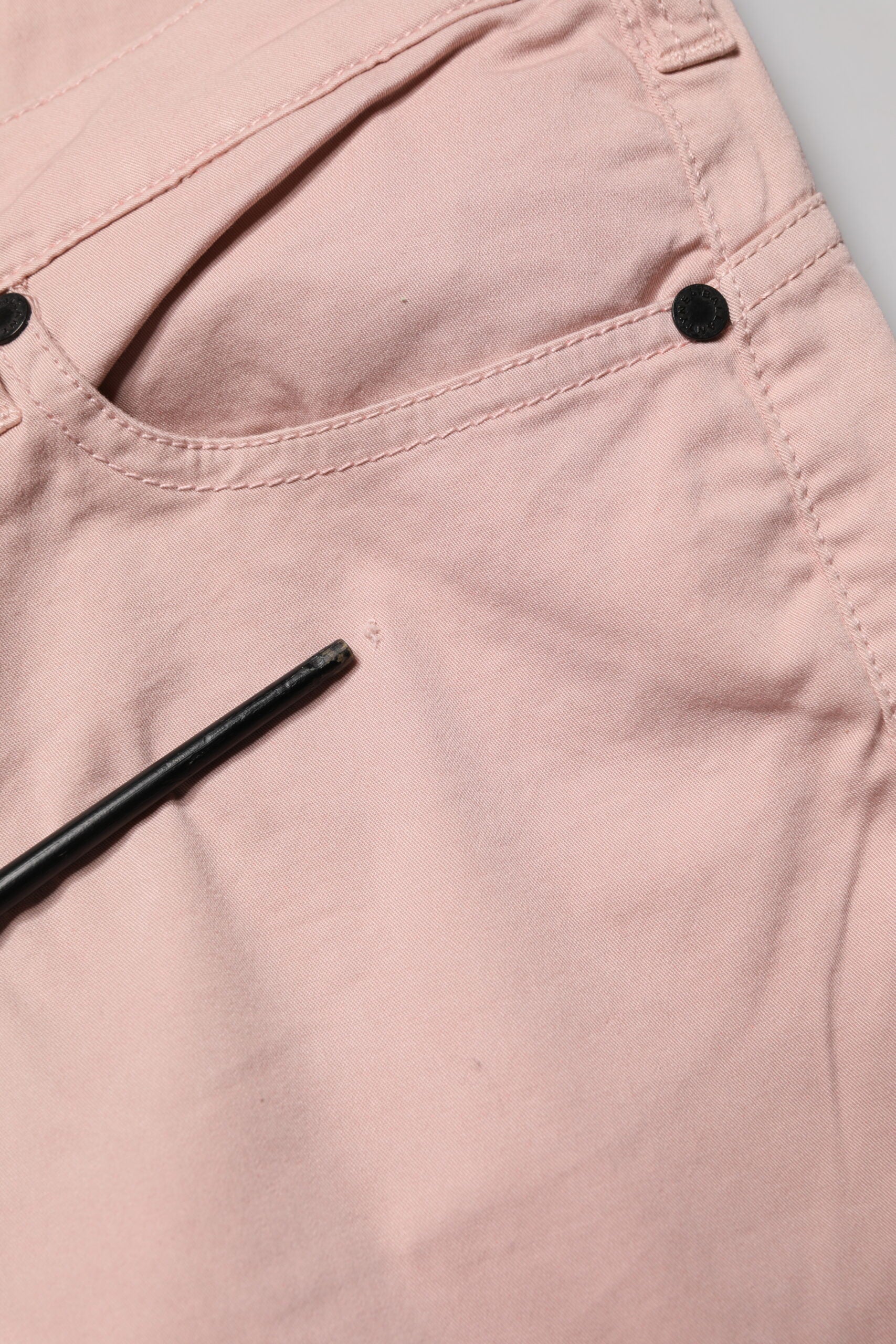 Pink pants on a white surface