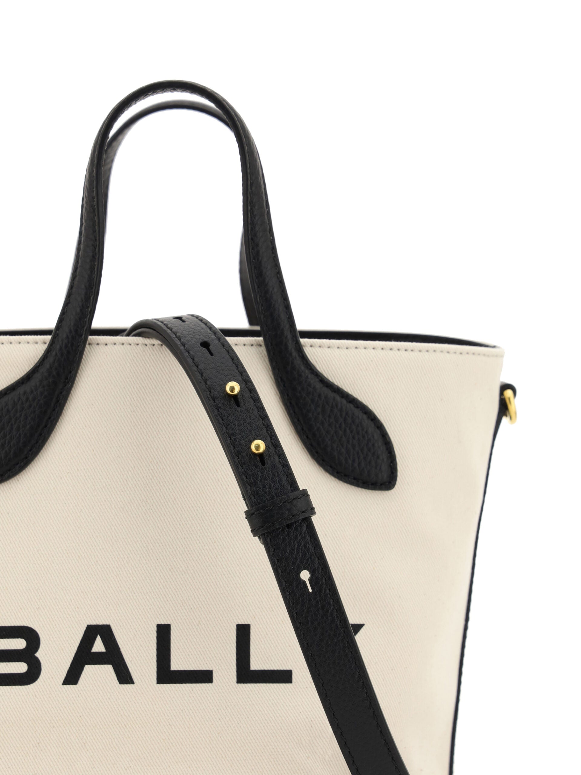 Black straps on a beige bag