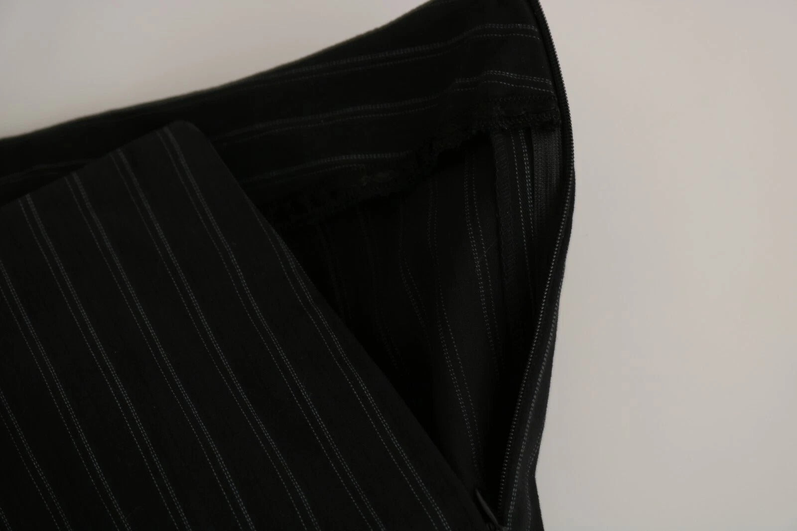 A pair of black high waist straight dress trousers with a visible zipper
