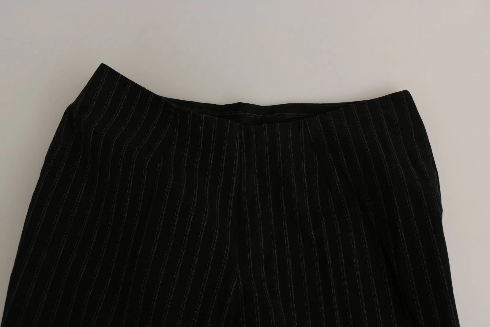 A pair of black high waist straight dress trousers with a patterned design