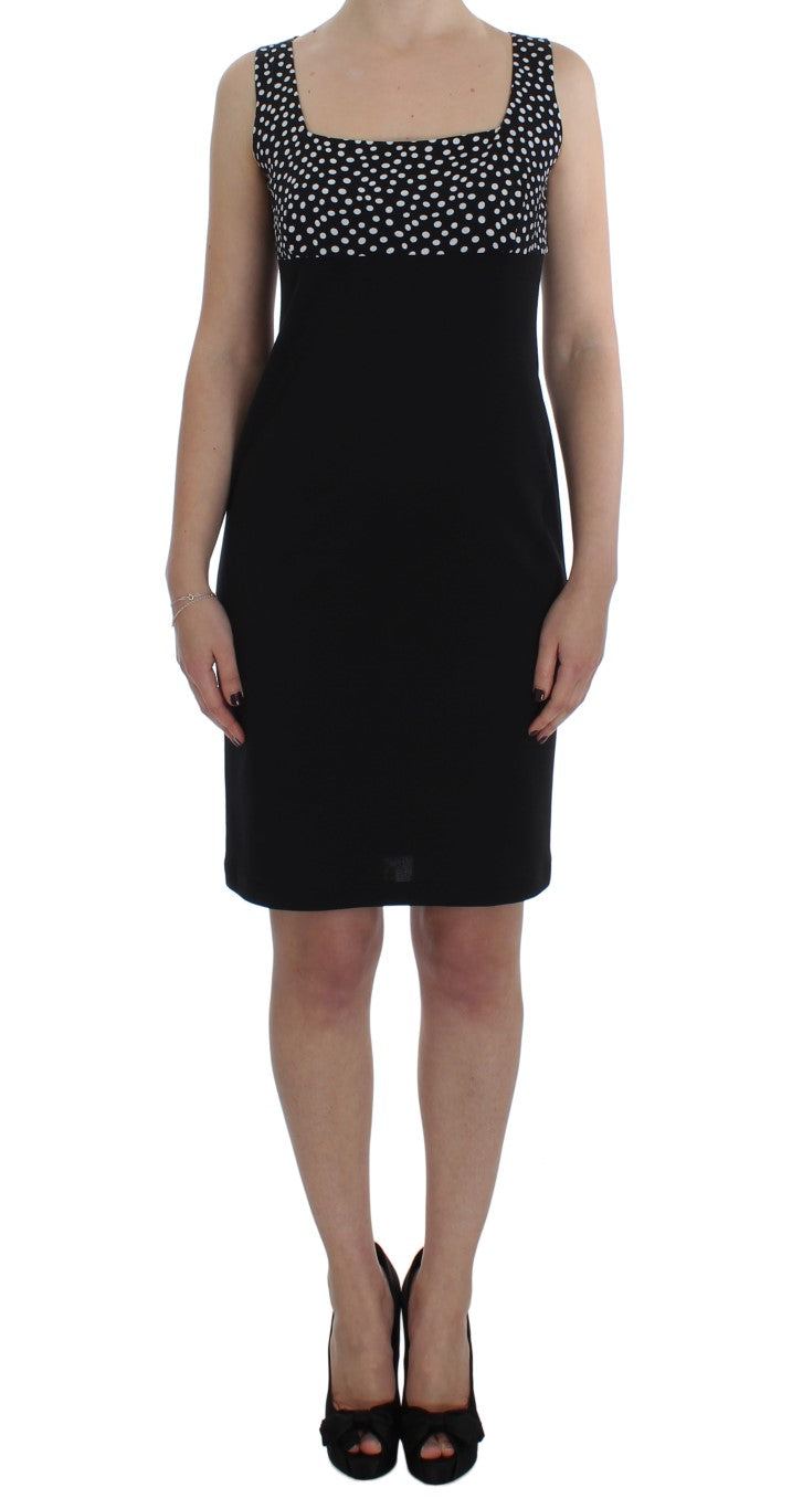 A black dress with a white polka dot pattern on the bodice and sleeves