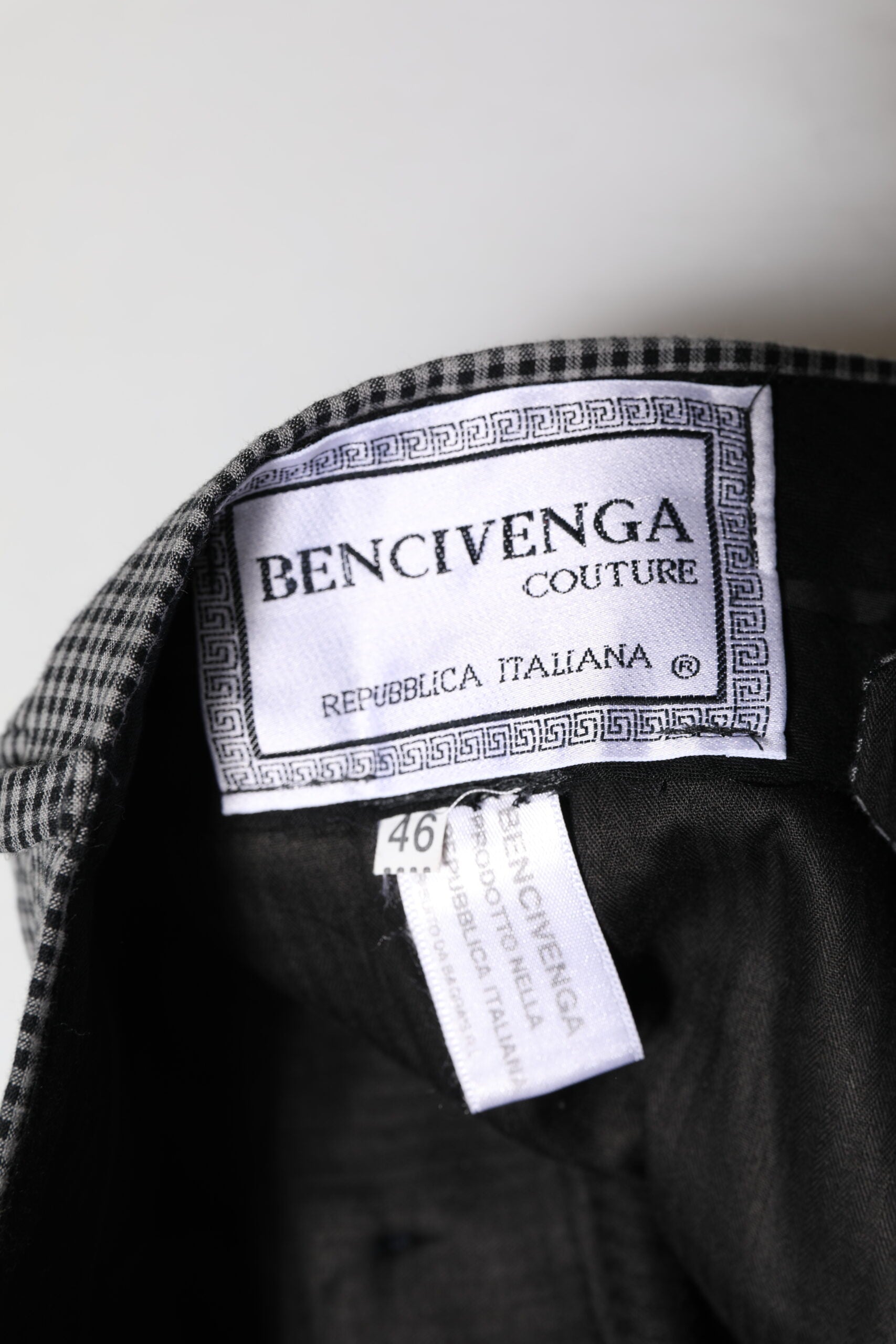 A pair of black and white checkered tapered dress pants by Bencivenga