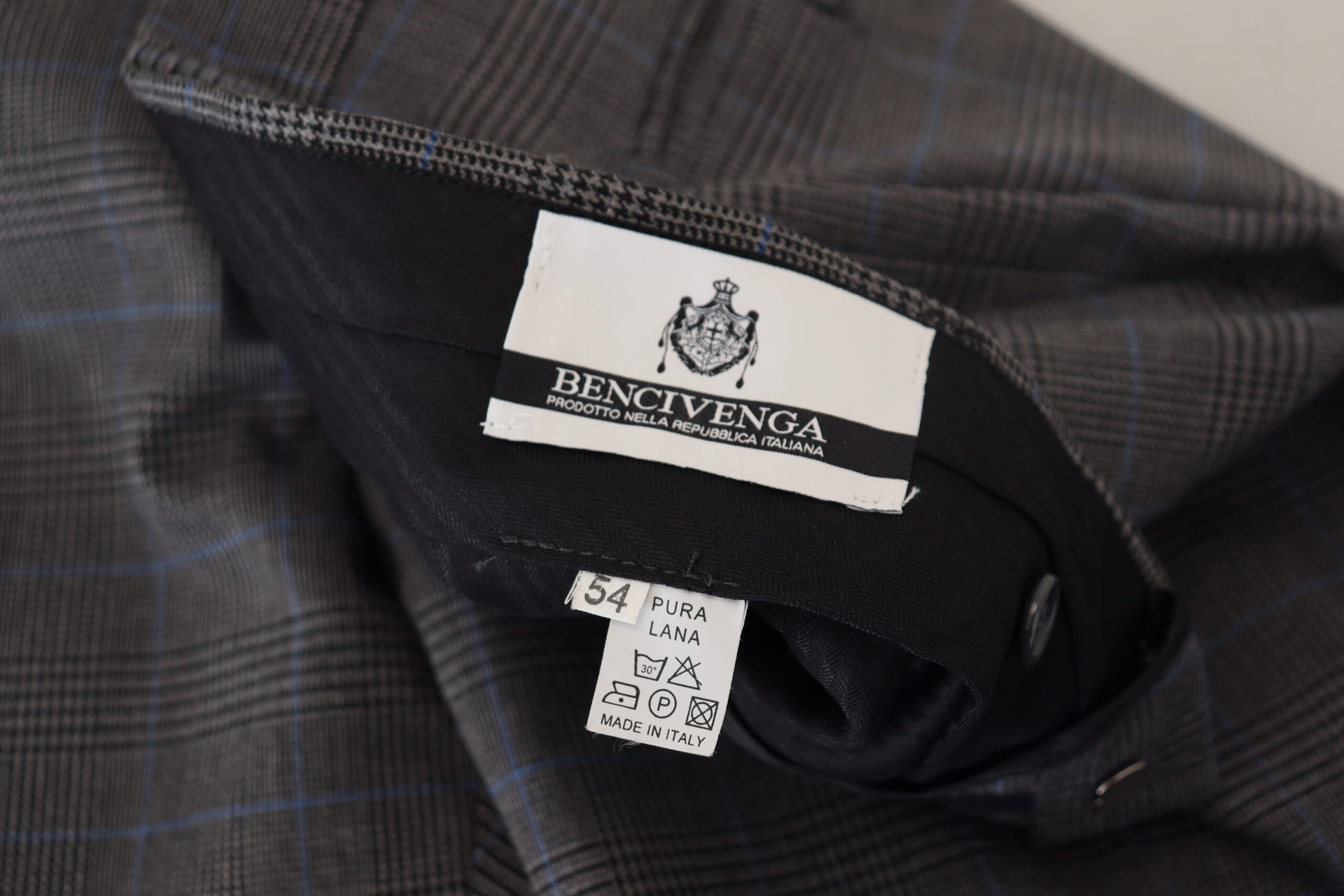 A pair of gray checkered wool dress pants from Bencivenga, with a label visible on the waistband