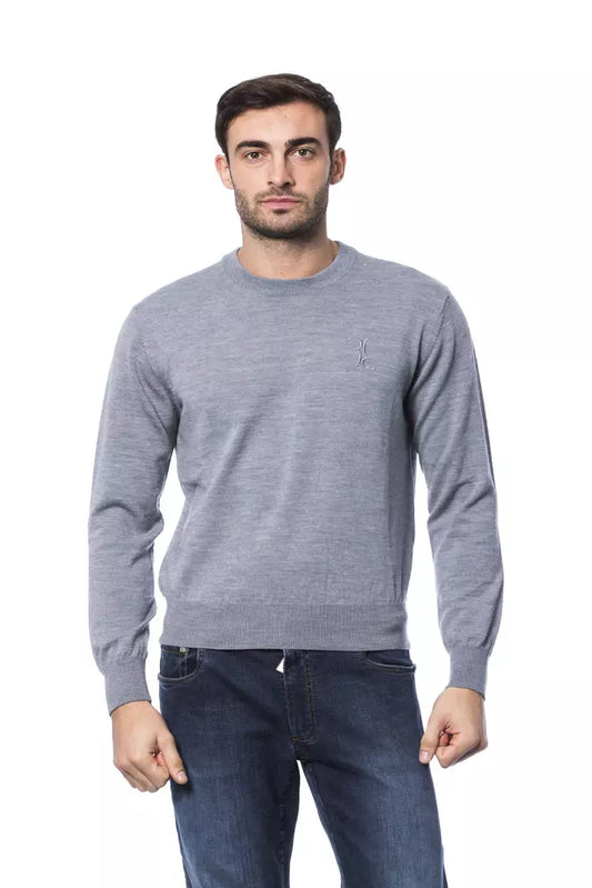 Man wearing gray sweater and blue jeans