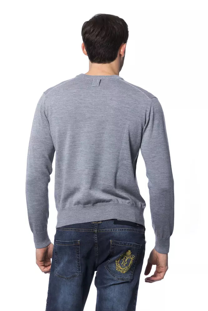 Man wearing gray sweater and blue jeans