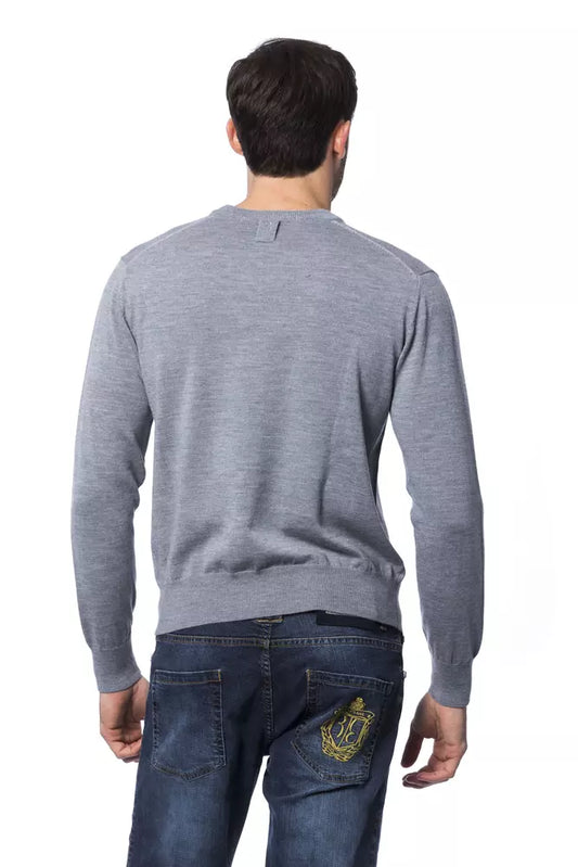 Man wearing gray sweater and blue jeans
