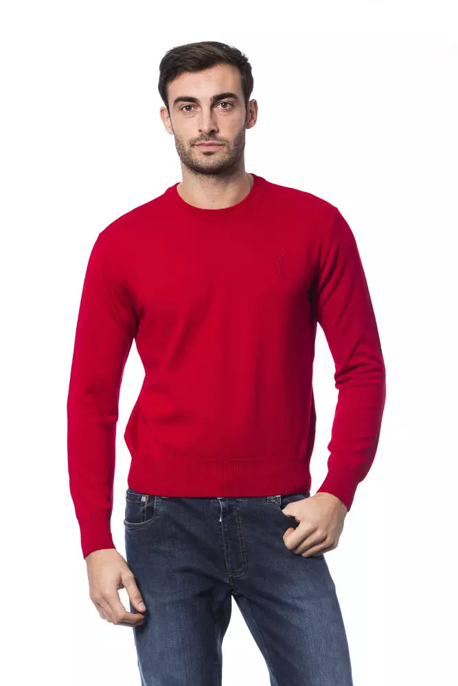 Man wearing red long sleeve sweater and blue jeans