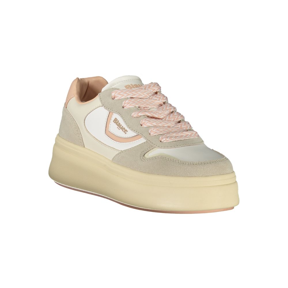 A women's sneaker with a tan base, pink accents, and white laces